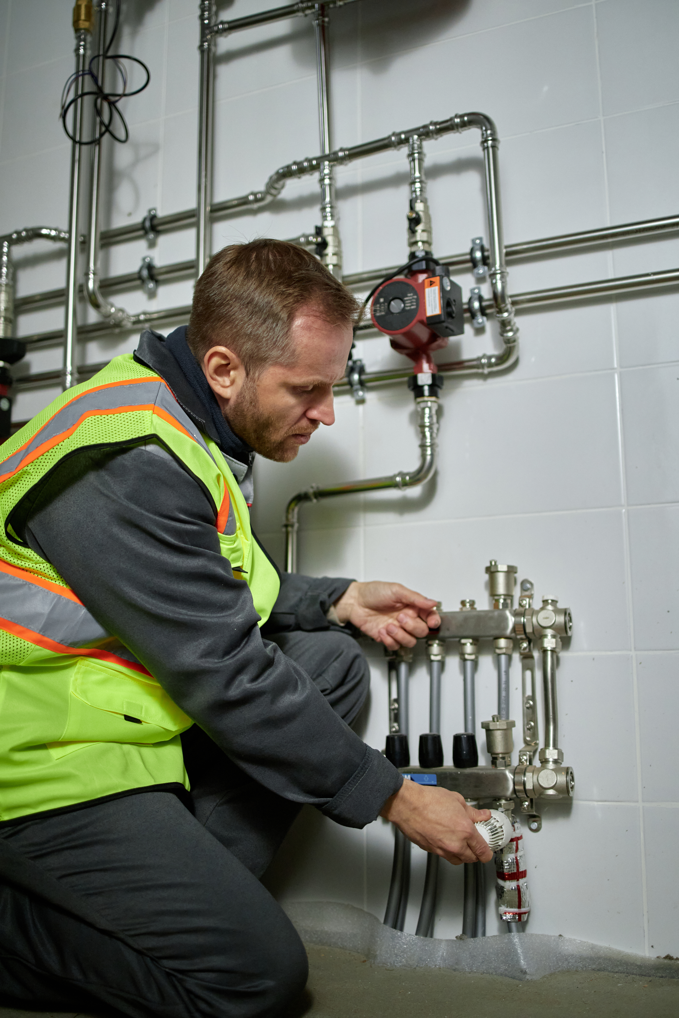 Rocha plumber installing a manifold valve assembly